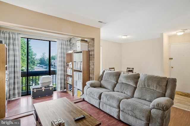 living room featuring wood finished floors and visible vents