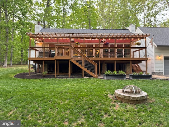 back of property with stairway, a pergola, a chimney, and an outdoor fire pit
