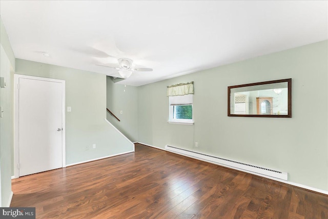 unfurnished room with stairway, a baseboard radiator, wood finished floors, and ceiling fan