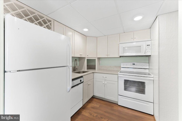 kitchen featuring a sink, white appliances, light countertops, recessed lighting, and white cabinetry