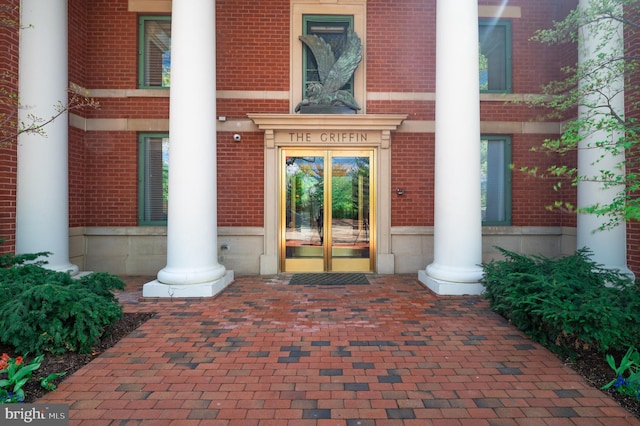 doorway to property with french doors and brick siding