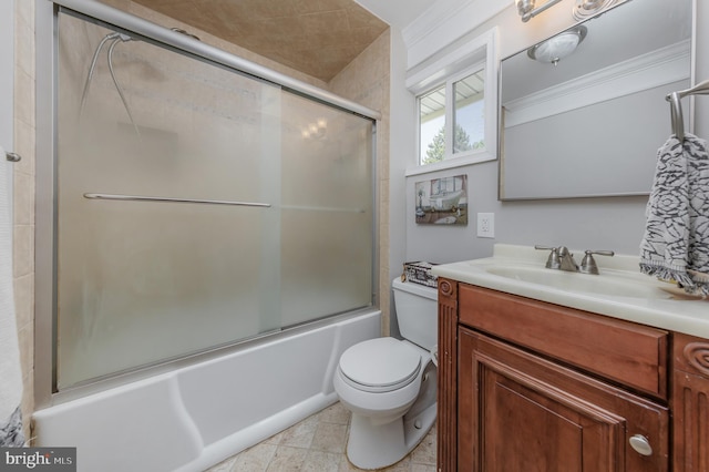 bathroom featuring vanity, combined bath / shower with glass door, and toilet