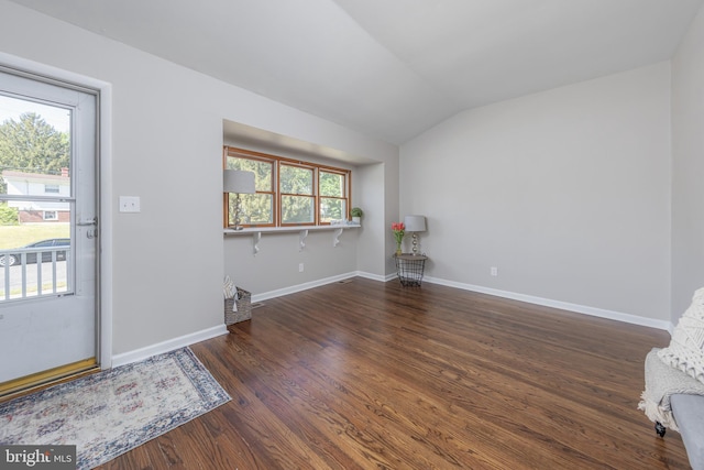 entryway featuring baseboards, wood finished floors, and lofted ceiling