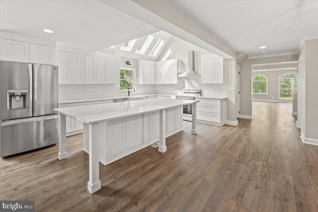 7746 Emerson Burrier Rd, Mount Airy, MD 21771 - kitchen with a center island, wall chimney exhaust hood, white cabinets, backsplash, and stainless steel appliances