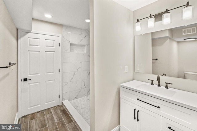 7746 Emerson Burrier Rd, Mount Airy, MD 21771 - full bathroom with visible vents, baseboards, wood finish floors, and a tile shower