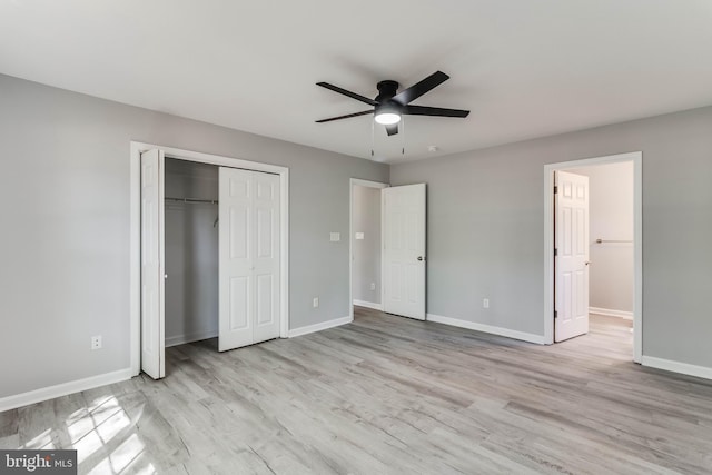 unfurnished bedroom featuring baseboards, a ceiling fan, a closet, and wood finished floors