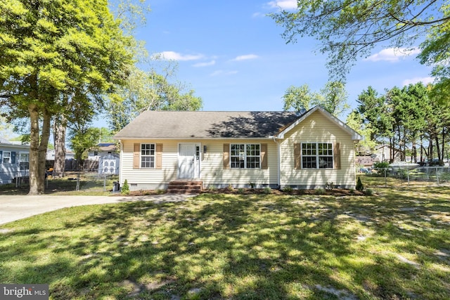 view of front of property with a storage shed, fence, a front yard, and crawl space