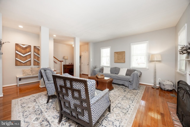 living room featuring stairway, hardwood / wood-style flooring, baseboards, and recessed lighting