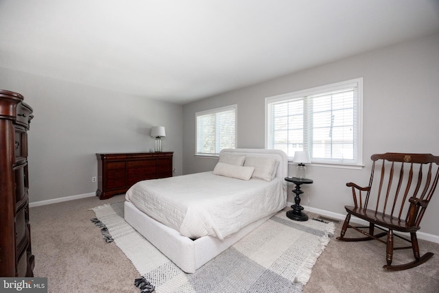 bedroom featuring carpet and baseboards
