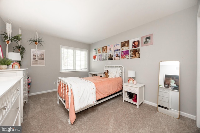 bedroom featuring baseboards and carpet flooring