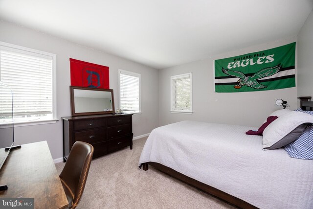 carpeted bedroom featuring baseboards