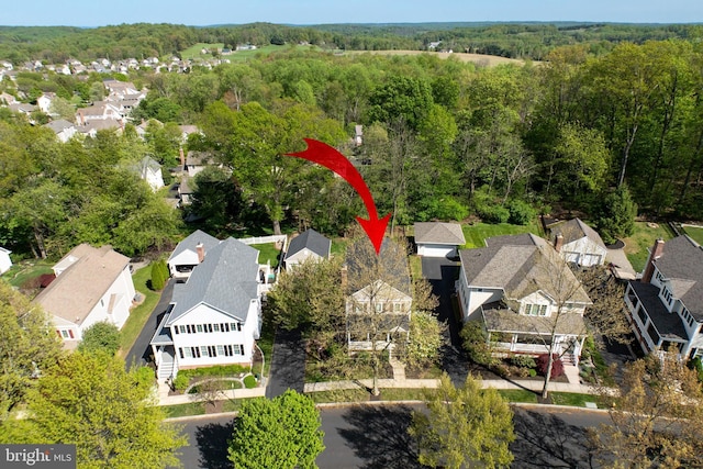 birds eye view of property with a forest view and a residential view