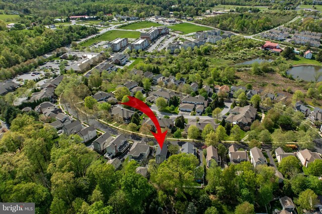 birds eye view of property featuring a water view and a residential view