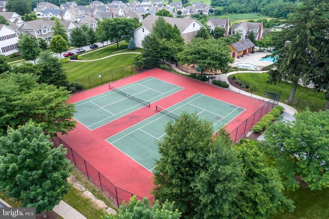 view of sport court featuring fence and a residential view