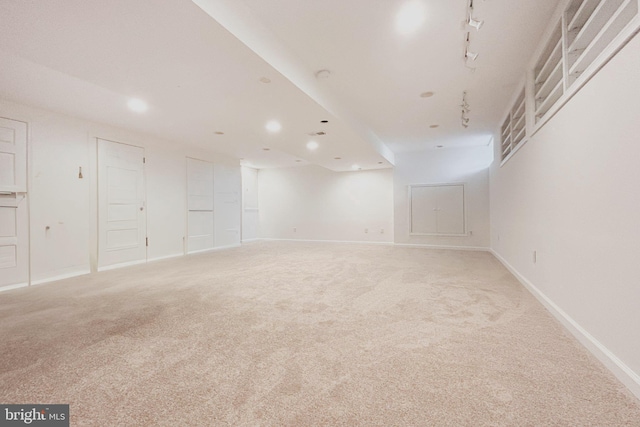 finished basement featuring baseboards, light carpet, and recessed lighting