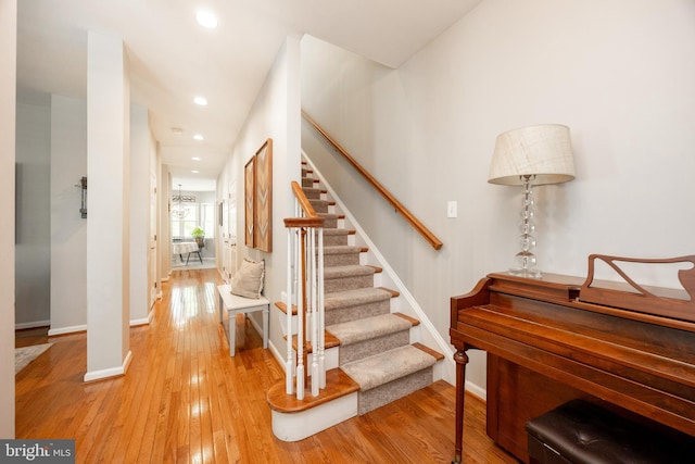 stairs with baseboards, recessed lighting, and hardwood / wood-style flooring