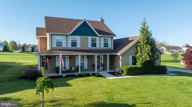 view of front of property featuring roof with shingles, a chimney, a porch, and a front yard