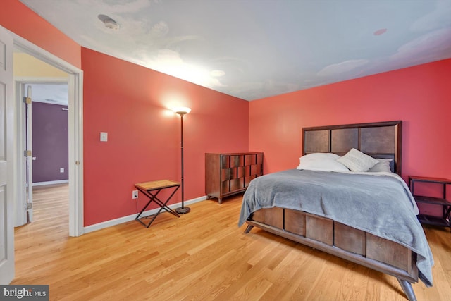 bedroom featuring wood finished floors and baseboards
