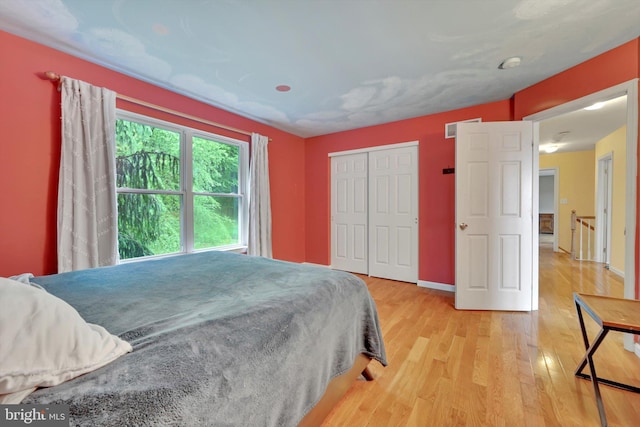 bedroom featuring wood finished floors and a closet
