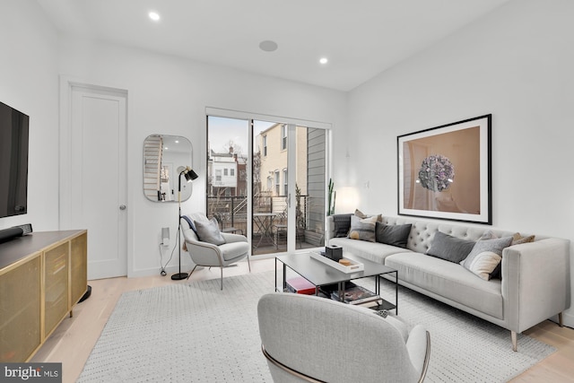 living room with light wood-style floors and recessed lighting