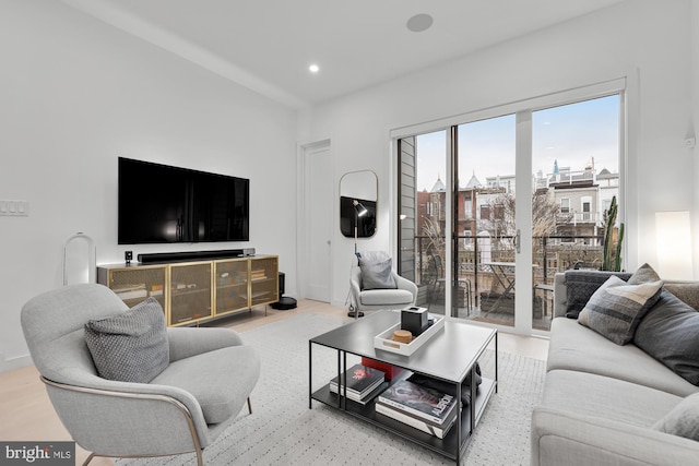 living area with recessed lighting, baseboards, and wood finished floors