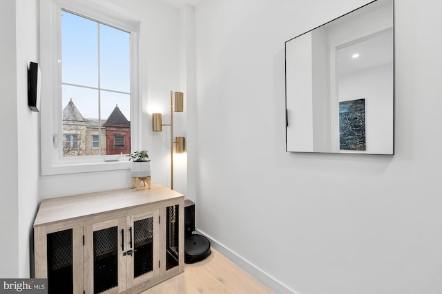 interior space featuring baseboards and wood finished floors