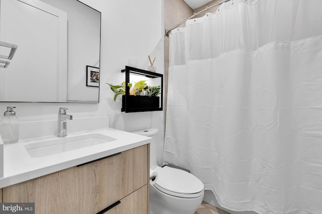 bathroom featuring toilet and vanity