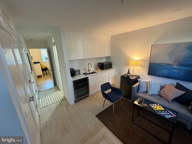 living room with light wood-style flooring and wine cooler