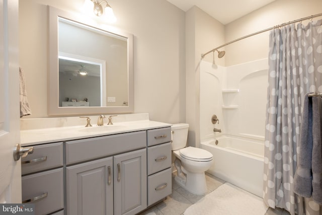 full bathroom featuring tile patterned floors, shower / bathtub combination with curtain, vanity, and toilet