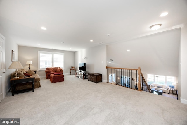 carpeted living room featuring recessed lighting, baseboards, and a healthy amount of sunlight