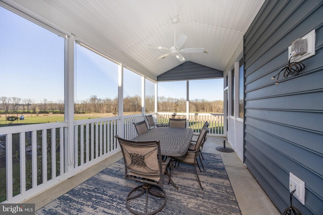 sunroom / solarium with outdoor dining space and ceiling fan