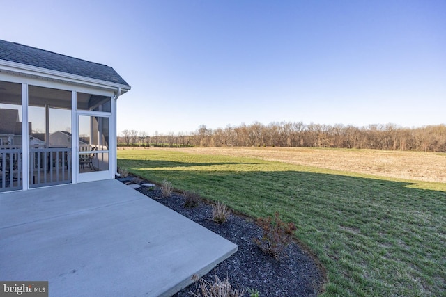 view of yard featuring a patio area and a sunroom