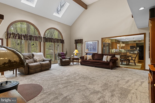 carpeted living room with recessed lighting, a skylight, high vaulted ceiling, and beamed ceiling