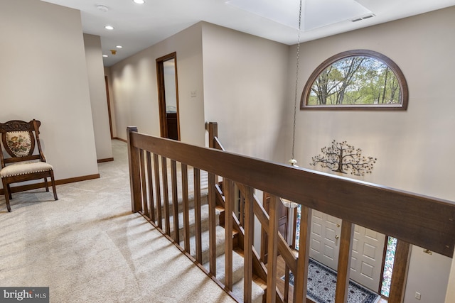 hallway featuring carpet, recessed lighting, baseboards, an upstairs landing, and visible vents