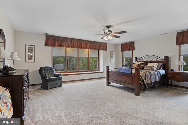 bedroom featuring baseboards, visible vents, ceiling fan, and carpet