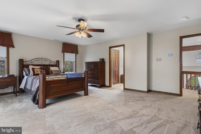 bedroom with baseboards, light carpet, a ceiling fan, and visible vents