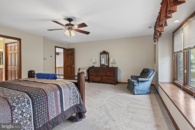 bedroom with ceiling fan, light colored carpet, and baseboards