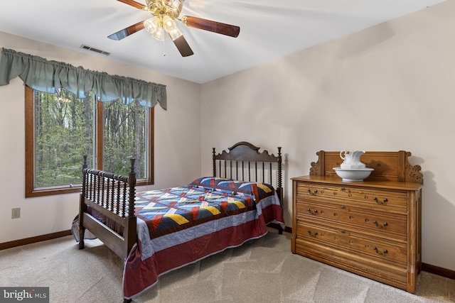 bedroom featuring carpet floors, baseboards, ceiling fan, and visible vents