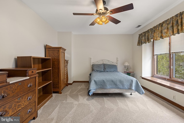 bedroom with light colored carpet, baseboards, visible vents, and ceiling fan