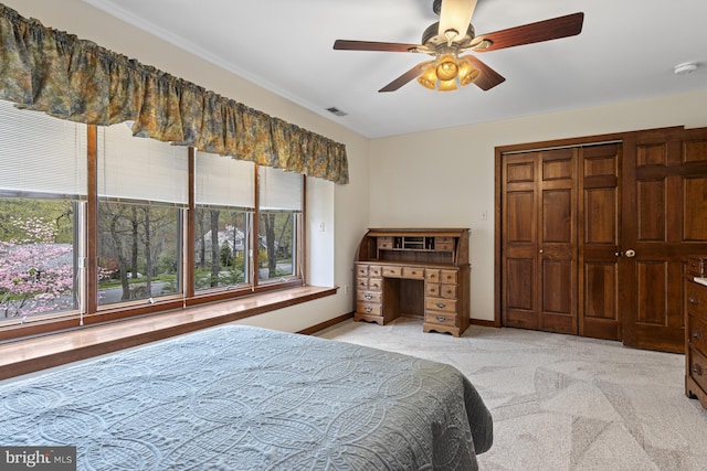 carpeted bedroom featuring baseboards, a ceiling fan, visible vents, and a closet