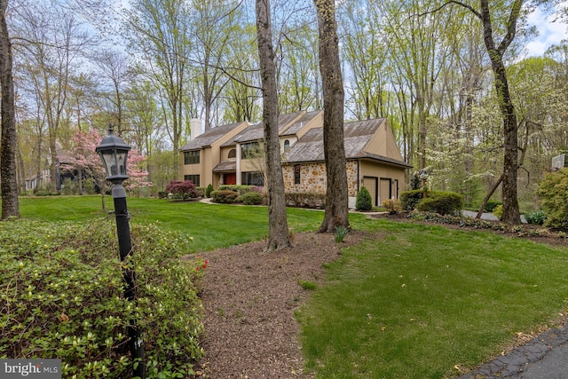 view of front of house with a chimney and a front lawn