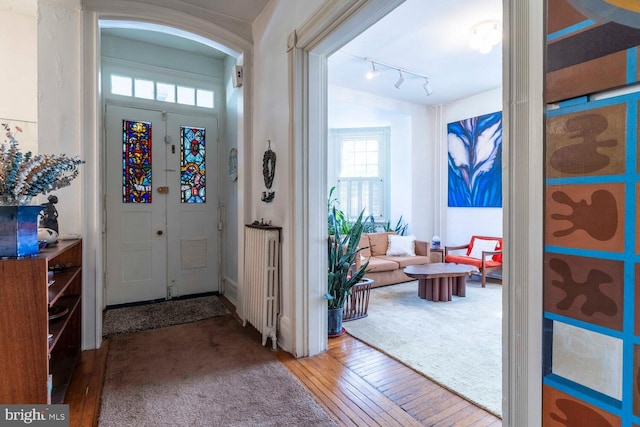 entryway featuring track lighting and hardwood / wood-style floors
