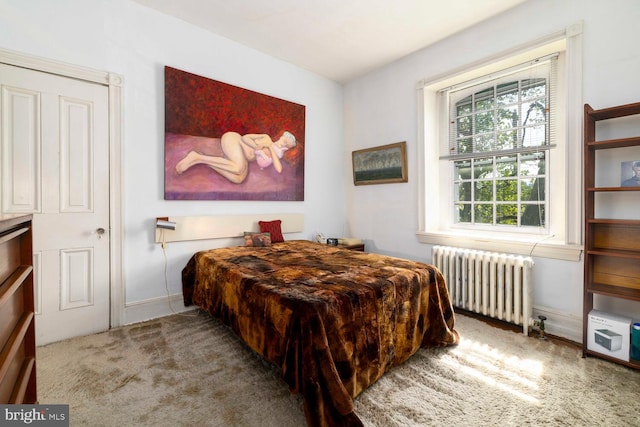 bedroom with carpet floors, radiator, and baseboards