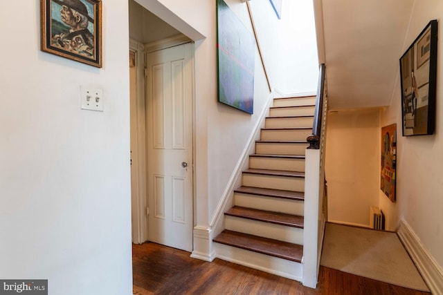 stairs featuring baseboards and wood finished floors