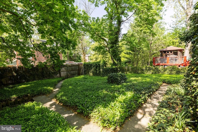 view of yard with fence and a wooden deck