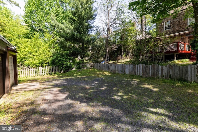 view of yard featuring fence and a wooden deck