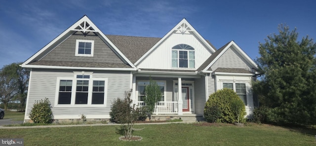 24840 Mistletoe Dr, Georgetown, DE 19947 - view of front of home with roof with shingles, covered porch, and a front yard