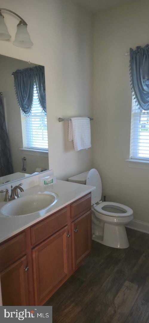 24840 Mistletoe Dr, Georgetown, DE 19947 - bathroom with vanity, wood finished floors, and toilet