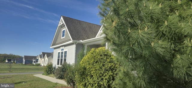 24840 Mistletoe Dr, Georgetown, DE 19947 - view of side of property featuring a shingled roof and a yard