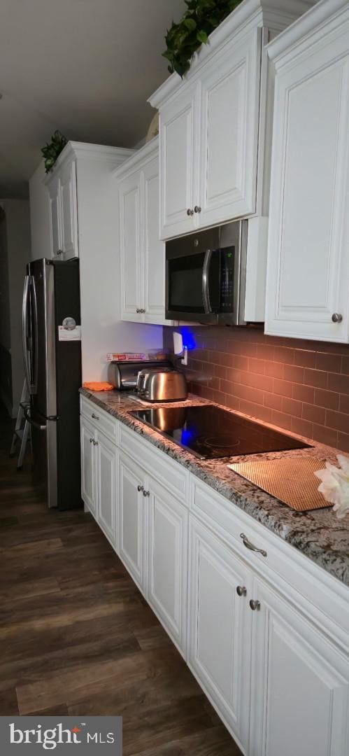 24840 Mistletoe Dr, Georgetown, DE 19947 - kitchen featuring white cabinets, stainless steel appliances, and dark wood-type flooring